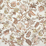 Close up of gently draped printed fabric in scrolling floral vine pattern in clay pink, grey tan and brown on white. 