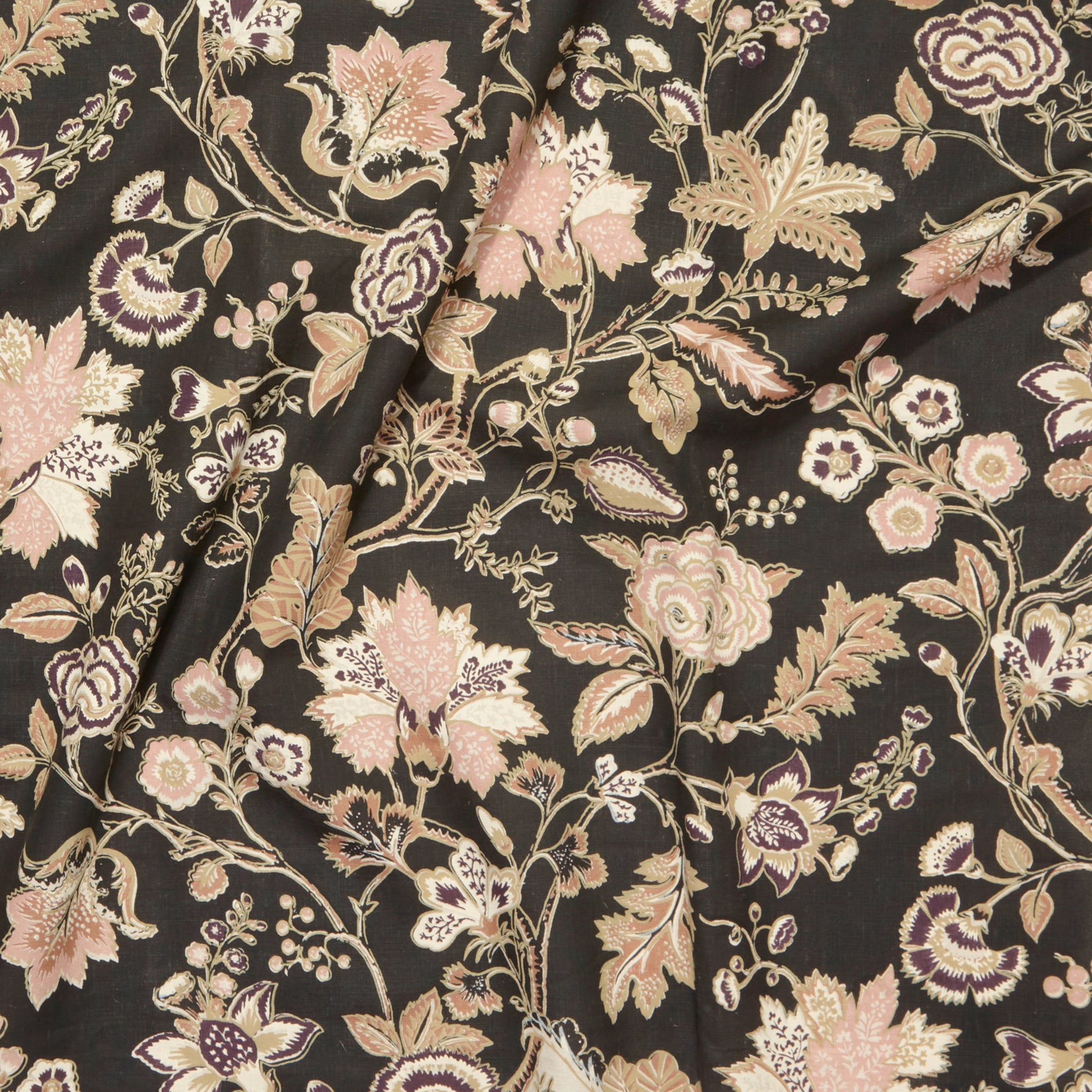 Close up of gently draped printed fabric in scrolling floral vine pattern in dark purple, blush pink, tan and brown on black.