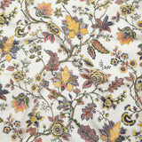 Close up of gently draped printed fabric in scrolling floral vine pattern in yellow, clay pink, orange, navy blue and olive green on white. 