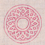 Detail of fabric in a repeating circular geometric print in fuchsia on a cream field.