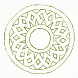 Detail of fabric in a repeating circular geometric print in green on a white field.