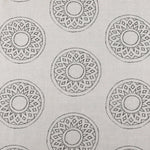 Detail of fabric in a repeating circular geometric print in gray on a greige field.