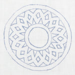 Detail of fabric in a repeating circular geometric print in blue on a white field.