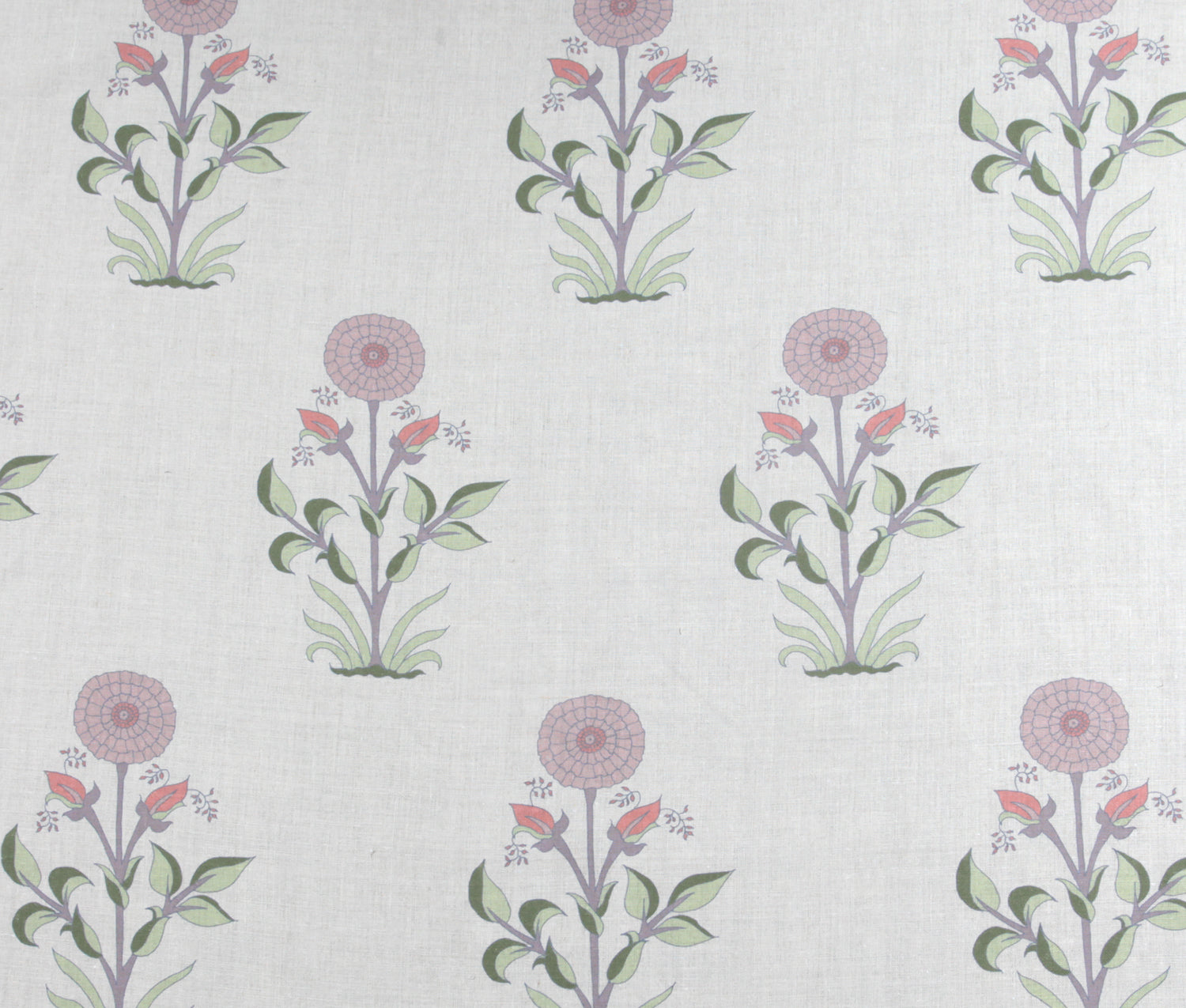 Detail of fabric in a large-scale marigold print in pink, purple and green on a white field.