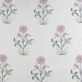 Detail of fabric in a large-scale marigold print in pink, purple and green on a white field.