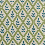 Detail of fabric in a lattice and leaf print in navy and green on a white field.
