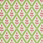 Detail of fabric in a lattice and leaf print in maroon and green on a white field.