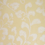 Cream leafy pattern on a yellow background