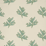 Pattern of green and blue leaf sprigs on a beige background