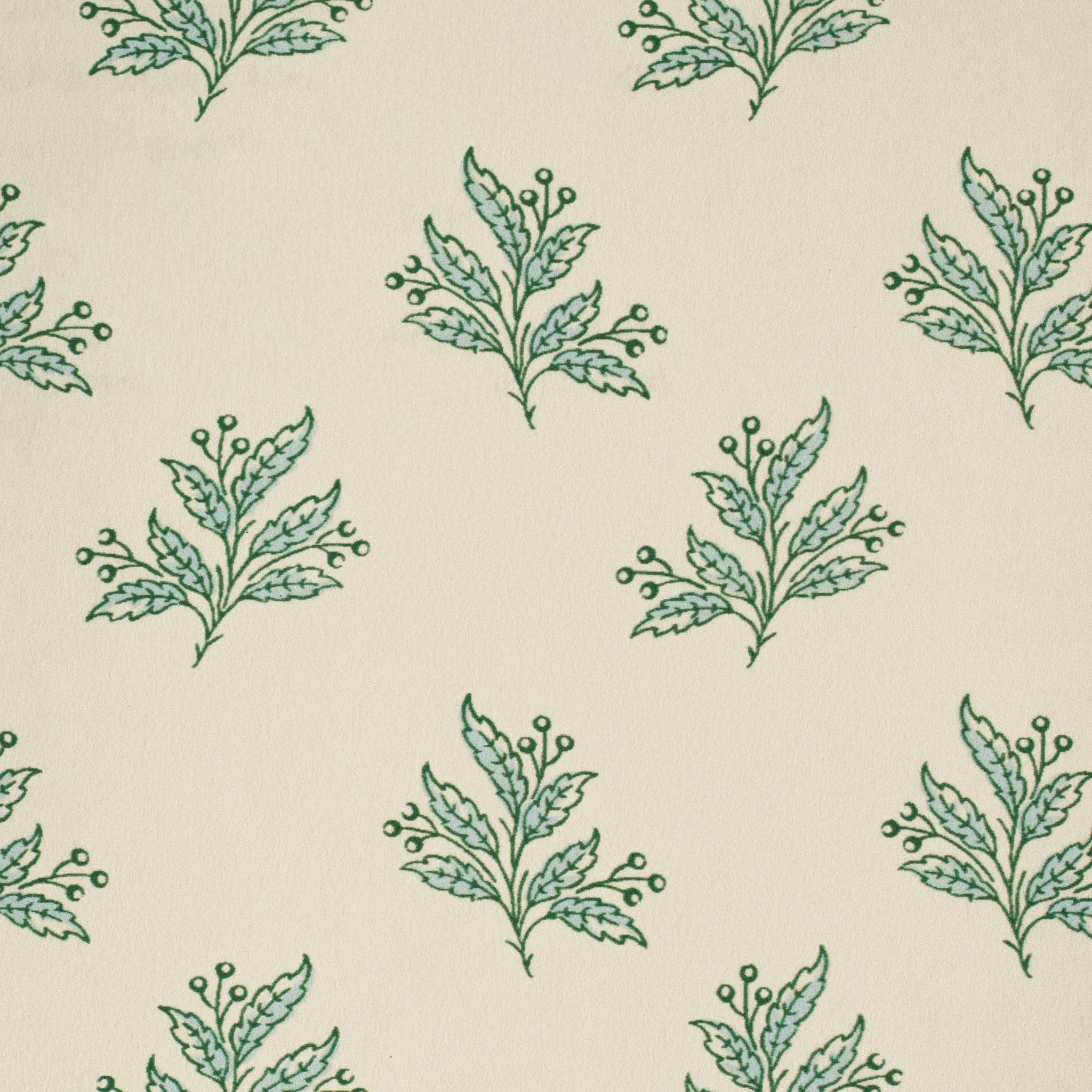 Pattern of green and blue leaf sprigs on a beige background