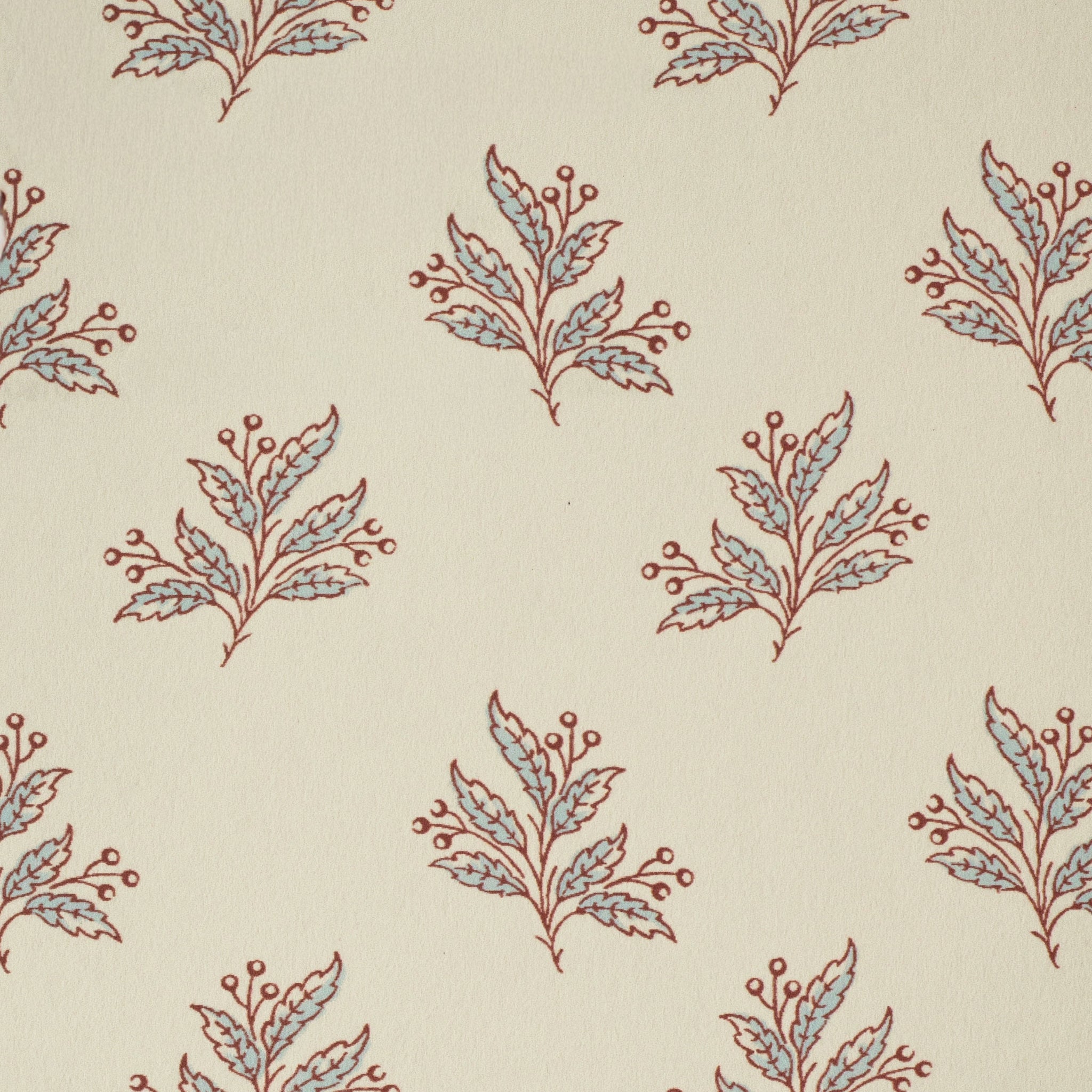 Pattern of red and blue leaf sprigs on a beige background