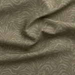 Detail of gently draped printed fabric with watercolor swirling stripe pattern in tonal muted sage green.