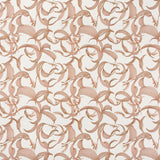 Detail of fabric in an abstract floral print in dusty rose on a cream field.