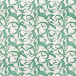 Detail of fabric in an abstract floral print in shades of turquoise on a cream field.