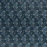 printed linen fabric in a floral and dot pattern in blue and white on a navy field.