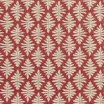Detail of fabric in a repeating fern leaf print in cream on a dark red field.