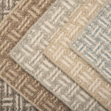 Collection of textured rugs with geometric patterns in neutral colors.