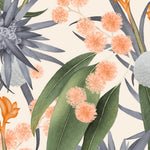 Detail of wallpaper in a large-scale botanical print in shades of blue, green and coral on a cream field.