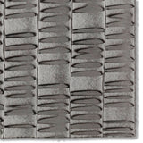 Detail of a hand-painted wallpaper swatch with an undulating ribbon pattern in charcoal.