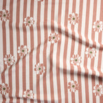 A close-up of a fabric pattern featuring vertical dusty rose and white stripes with scattered daisy-like flowers in white, dusty rose, and olive green.