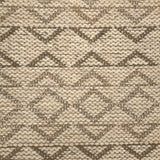 Handwoven rug detail in a geometric design in tan and brown