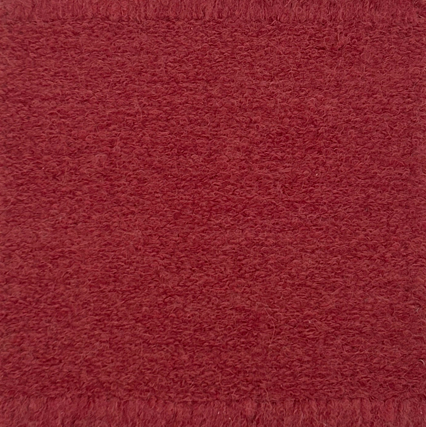 Bouclé rug in coral pink. 