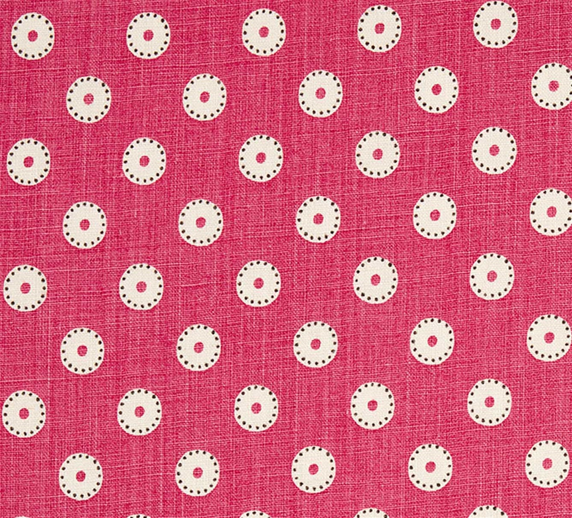 Detail of fabric in a playful dot print in cream and charcoal on a maroon field.