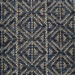 Handwoven rug detail in a diamond design in navy blue and black