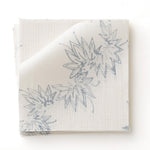 Fabric swatch with stripe pattern of stylized  blue leaves on a beige background