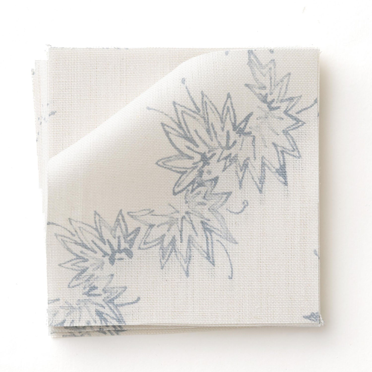 Fabric swatch with stripe pattern of stylized  blue leaves on a beige background