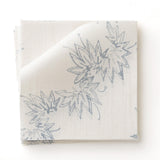 Fabric swatch with stripe pattern of stylized  blue leaves on a beige background