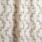 Draped fabric with stripe pattern of stylized dark brown leaves on a beige background