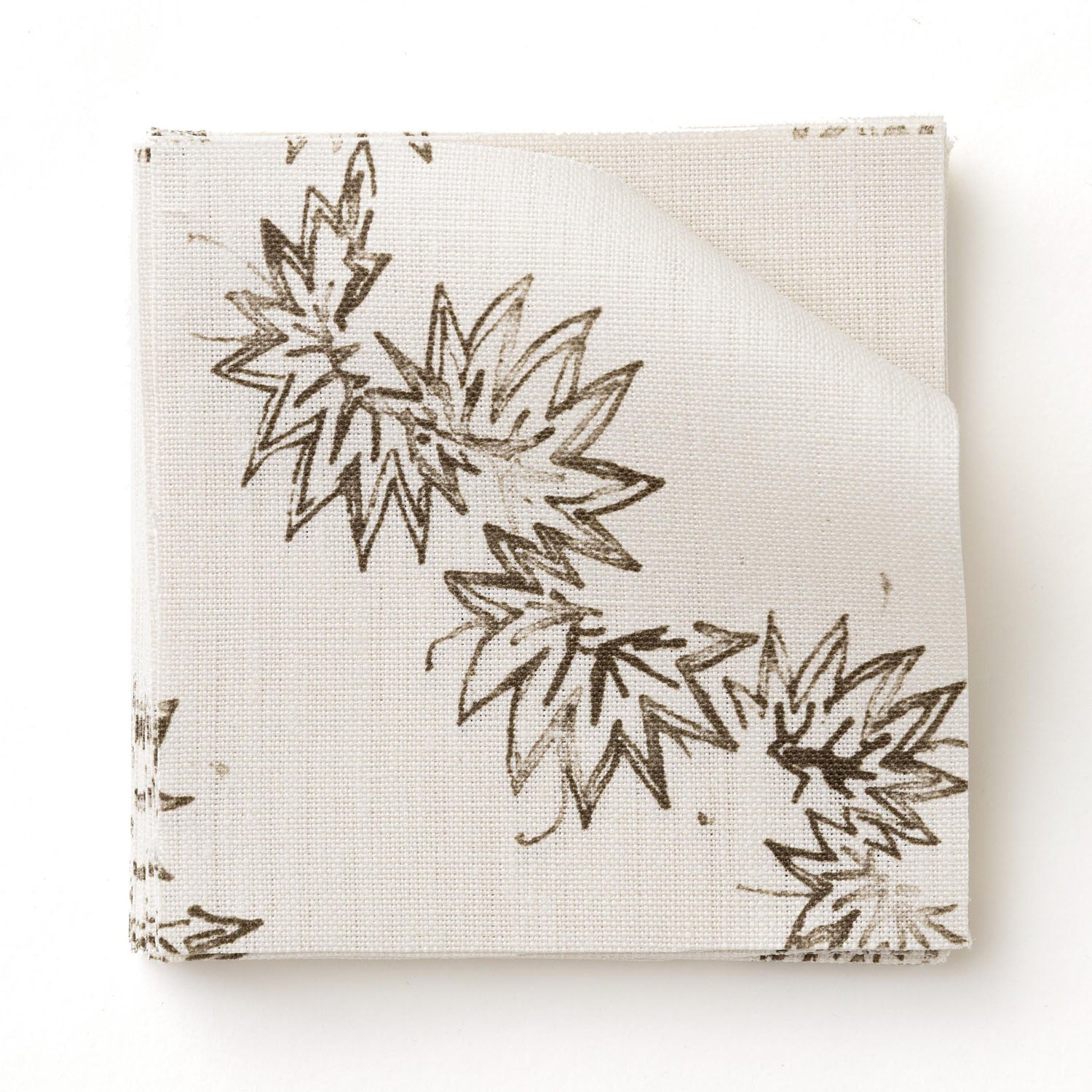 Fabric swatch with stripe pattern of stylized dark brown leaves on a beige background
