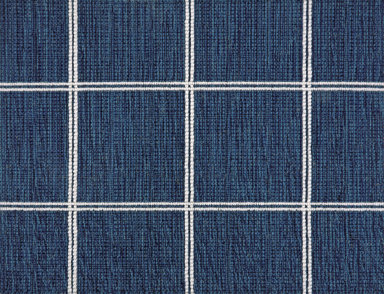 Broadloom carpet sample with windowpane grid in cream on a navy blue background. 