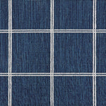 Broadloom carpet sample with windowpane grid in cream on a navy blue background. 