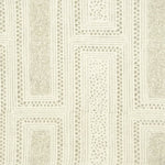 Detail of fabric in a complex interlocking geometric print in light brown on a cream field.
