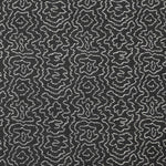 Detail of fabric in a minimalist wood grain print in white on a charcoal field.