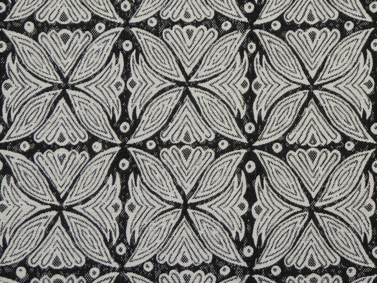 Detail of fabric in a botanical geometric print in shades of gray and charcoal.