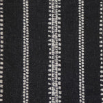 Detail of fabric in an irregular stripe print in white on a black field.