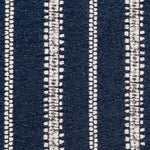 Detail of fabric in an irregular stripe print in white on an indigo field.