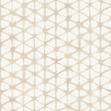 Detail of fabric in a painterly lattice print in tan on a cream field.