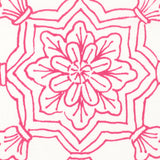 Detail of fabric in a floral medallion print in pink on a white field.