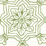 Detail of fabric in a floral medallion print in green on a white field.