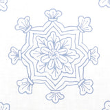 Detail of fabric in a floral medallion print in light blue on a white field.