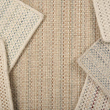 A scattered pile of broadloom carpets in a textural stripe in a range of colors.