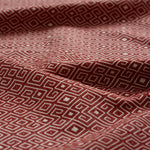 Red and white geometric patterned fabric gently draped