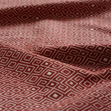 Red and white geometric patterned fabric gently draped