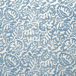 Fabric in a botanical paisley print in white on a blue field.