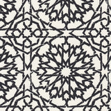 Detail of wallpaper in a small-scale lattice print in black on a cream field.