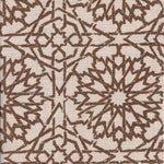Detail of fabric in a small-scale lattice print in brown on a cream field.